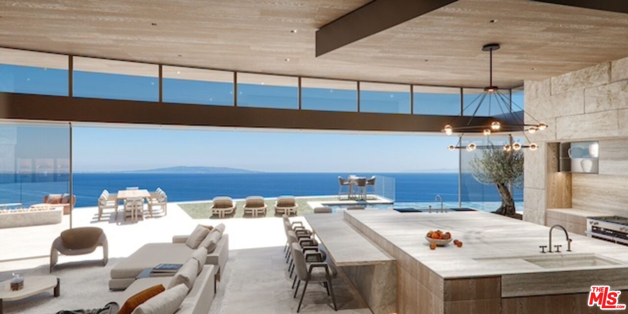 5024 Carbon Beach Terrace Malibu, CA 90265 - Photo 18 of 35 a dining table chairs in a kitchen