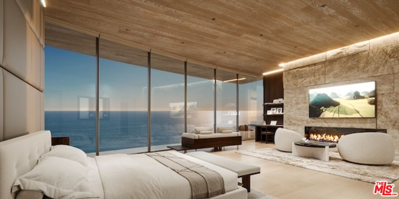 5024 Carbon Beach Terrace Malibu, CA 90265 - Photo 26 of 35 a bedroom with double vanity two couches and a flat screen tv