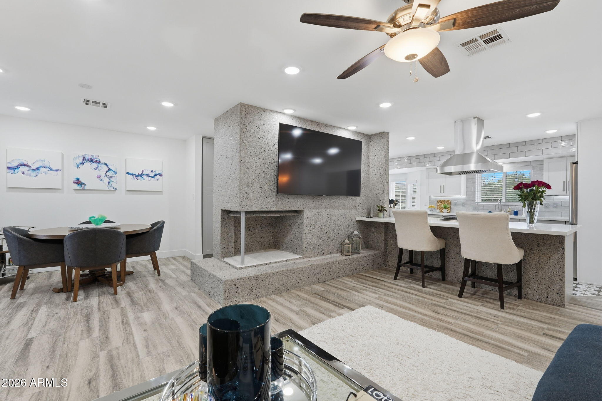 5149 North 34th Street Phoenix, AZ 85018 - Photo 15 of 70 a living room with furniture a dining table and kitchen view
