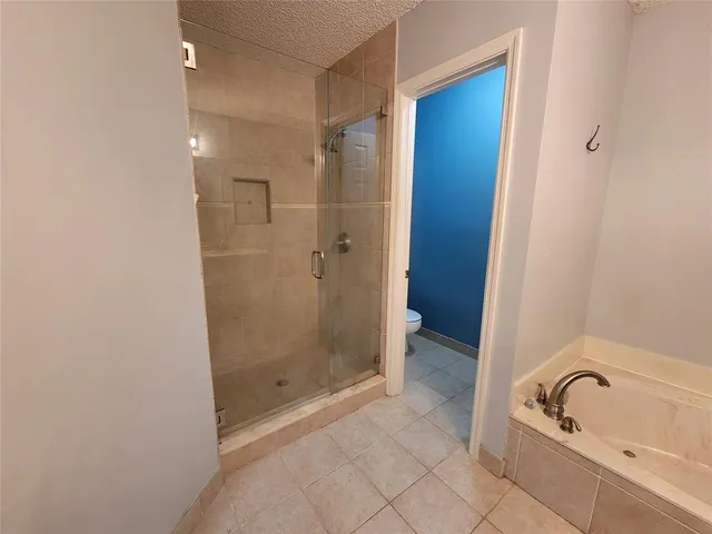 a bathroom with a tub and shower