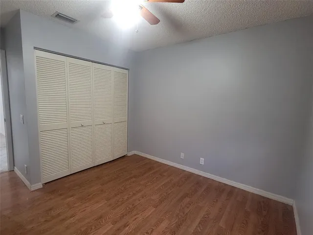an empty room with wooden floor