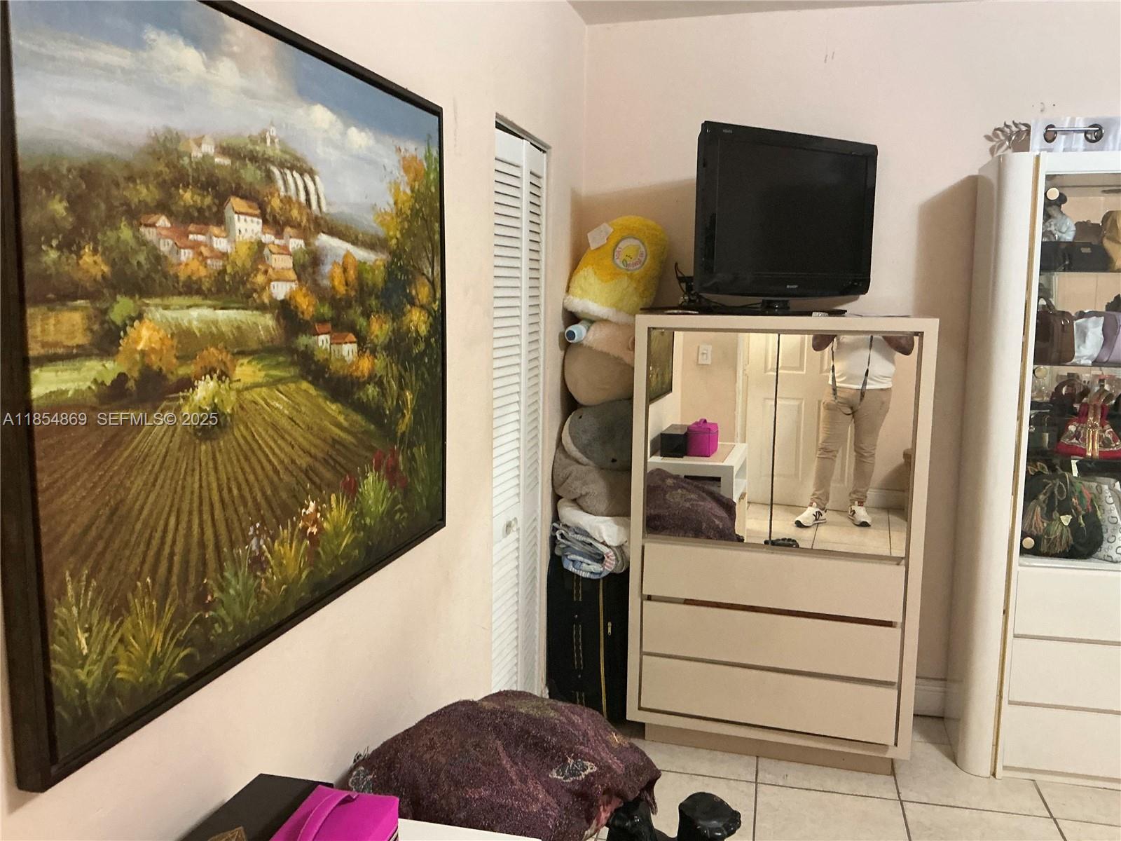 1855 Northwest 32nd Street Miami, FL 33142 - Photo 11 of 23 a view of walk in closet with clothes and shoes