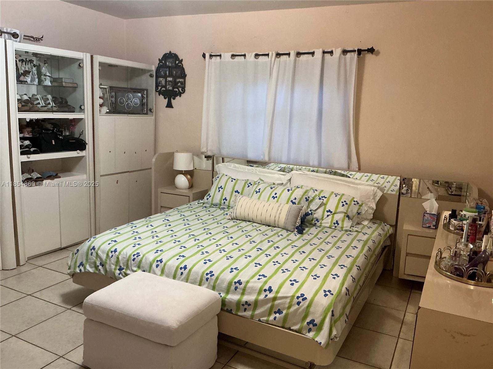 1855 Northwest 32nd Street Miami, FL 33142 - Photo 12 of 23 a bedroom with a bed and a window