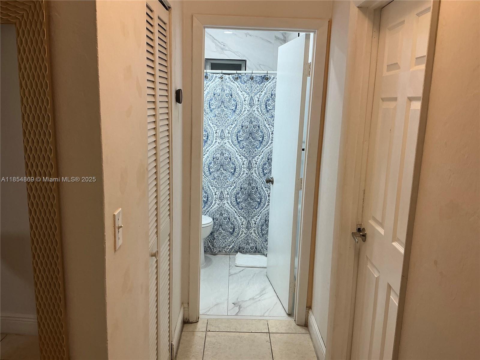 1855 Northwest 32nd Street Miami, FL 33142 - Photo 13 of 23 a bathroom with a glass door shower