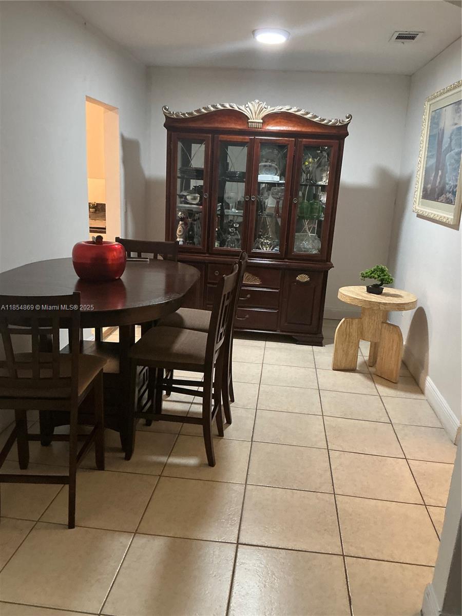 1855 Northwest 32nd Street Miami, FL 33142 - Photo 15 of 23 a living room with a couch and a table