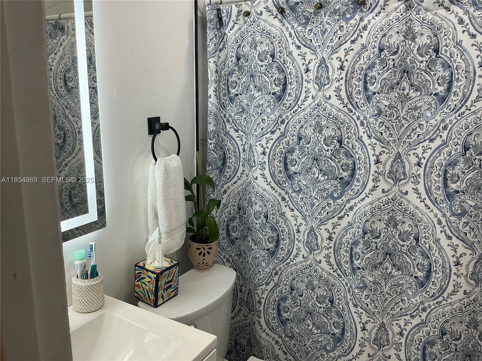 1855 Northwest 32nd Street Miami, FL 33142 - Photo 22 of 23 a bathroom with a toilet and a sink