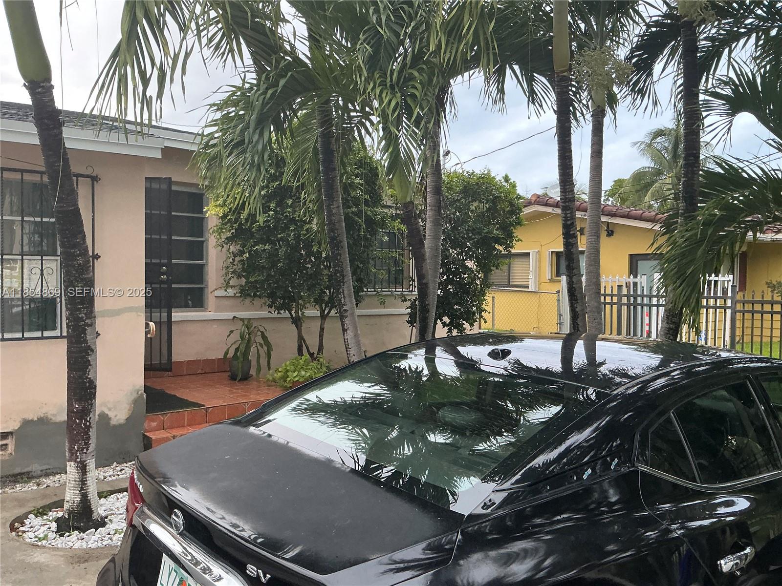 1855 Northwest 32nd Street Miami, FL 33142 - Photo 5 of 23 a view of a backyard with plants and a patio