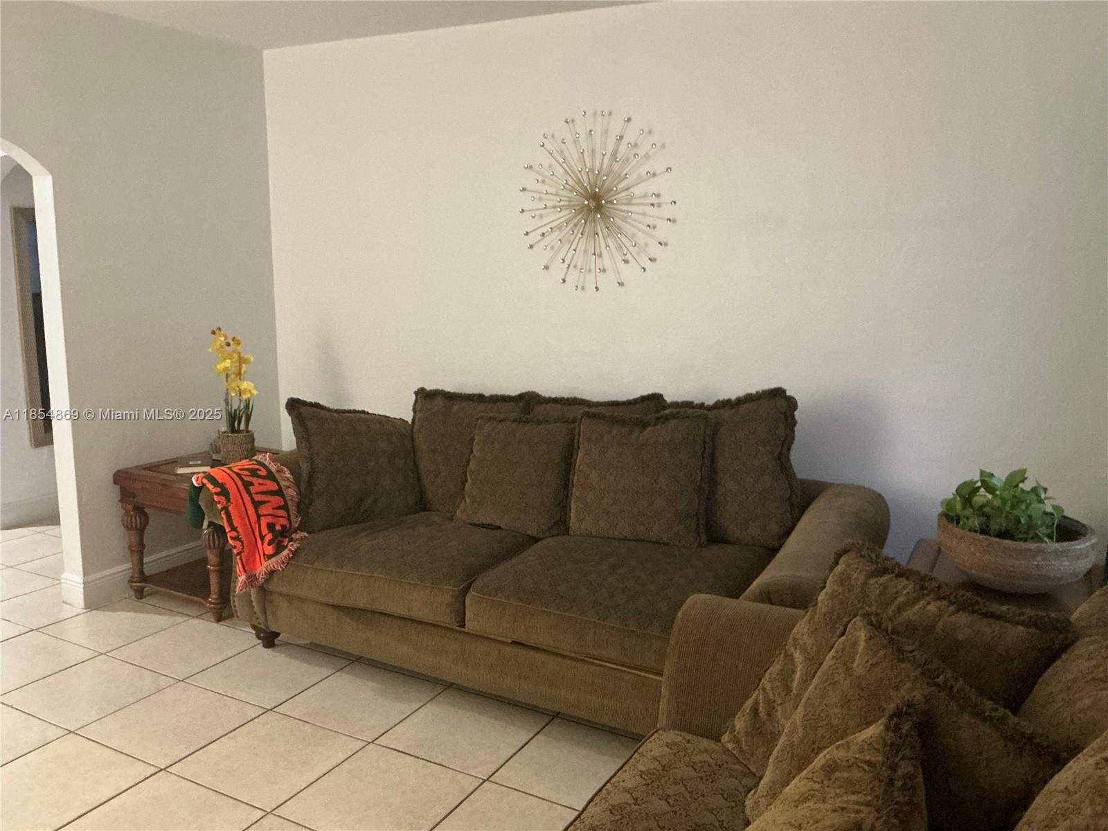 1855 Northwest 32nd Street Miami, FL 33142 - Photo 8 of 23 a living room with furniture and a couch