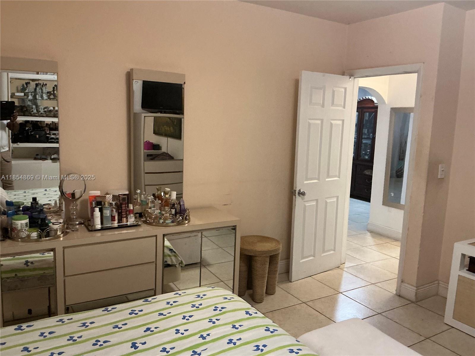 1855 Northwest 32nd Street Miami, FL 33142 - Photo 9 of 23 a bedroom with a bed and a cabinets