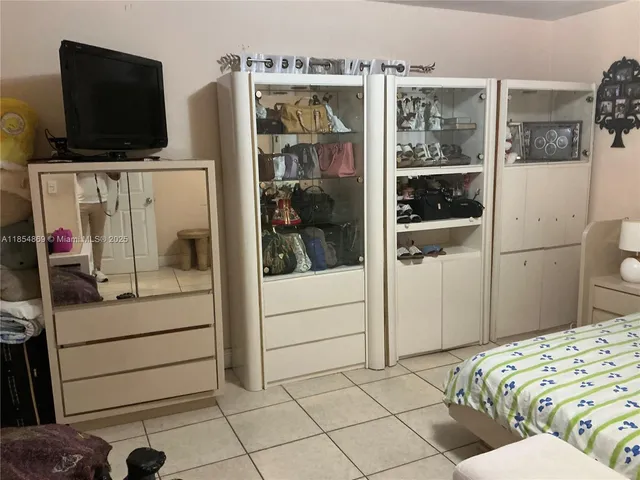 a bedroom with a bed and flat screen tv