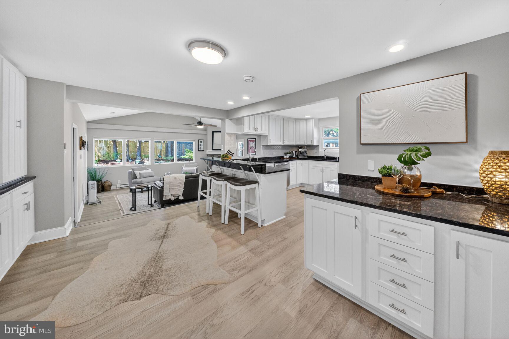 a kitchen with white cabinets and appliances