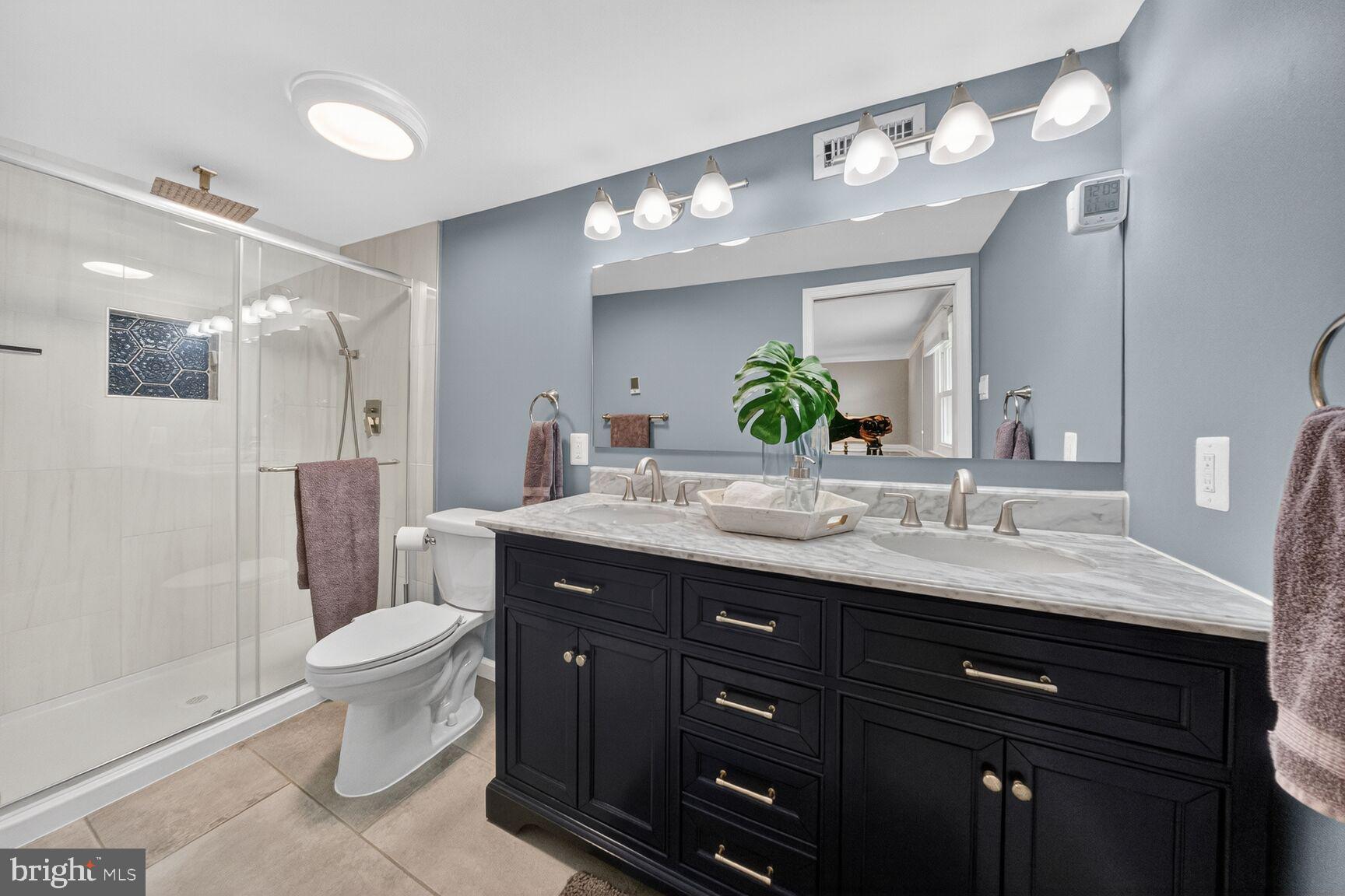 7007 Lemay Road Rockville, MD 20851 - Photo 17 of 37 a bathroom with a granite countertop double vanity sink mirror and toilet
