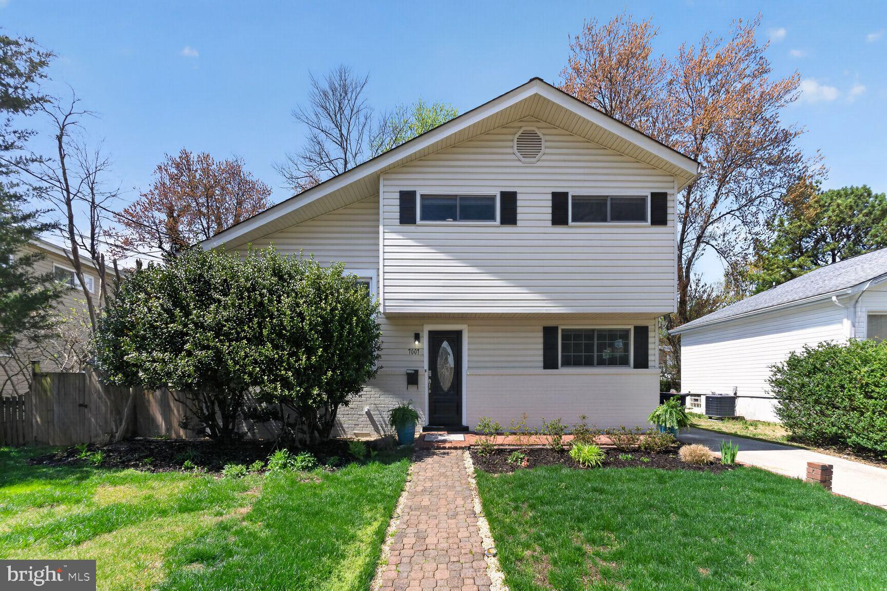 7007 Lemay Road Rockville, MD 20851 - Photo 2 of 37 a front view of a house with a garden and plants
