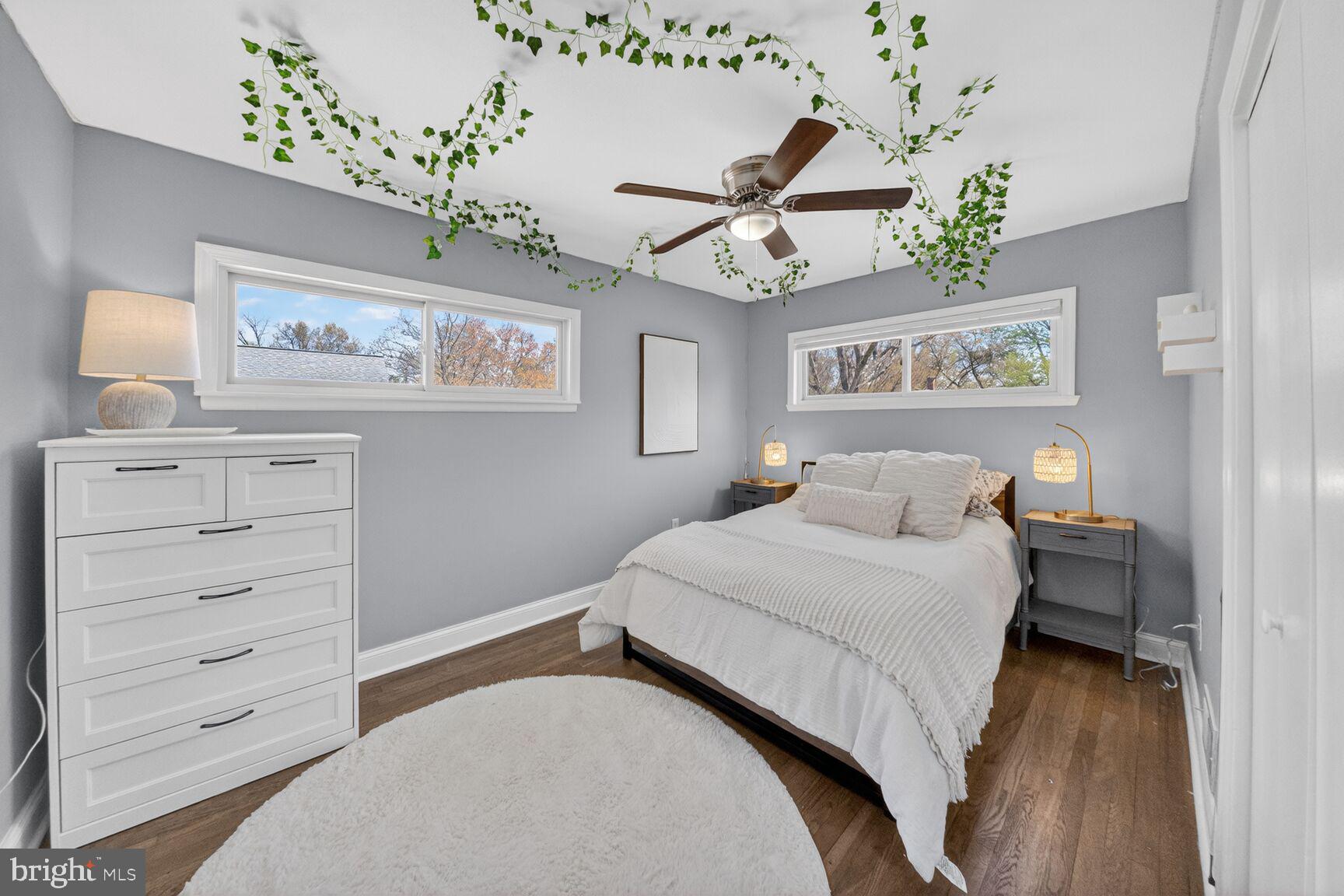 7007 Lemay Road Rockville, MD 20851 - Photo 25 of 37 a bedroom with a large bed and a chandelier