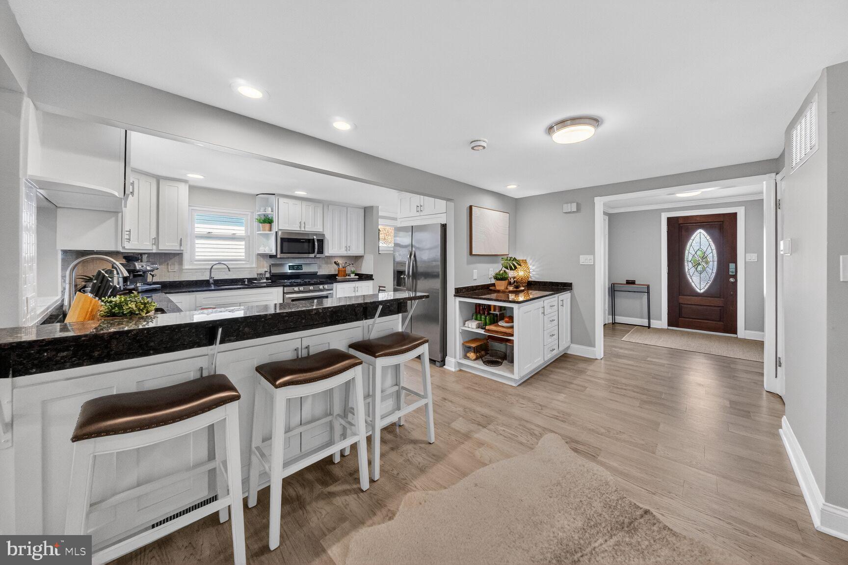 7007 Lemay Road Rockville, MD 20851 - Photo 5 of 37 a kitchen with granite countertop a stove a sink and a refrigerator