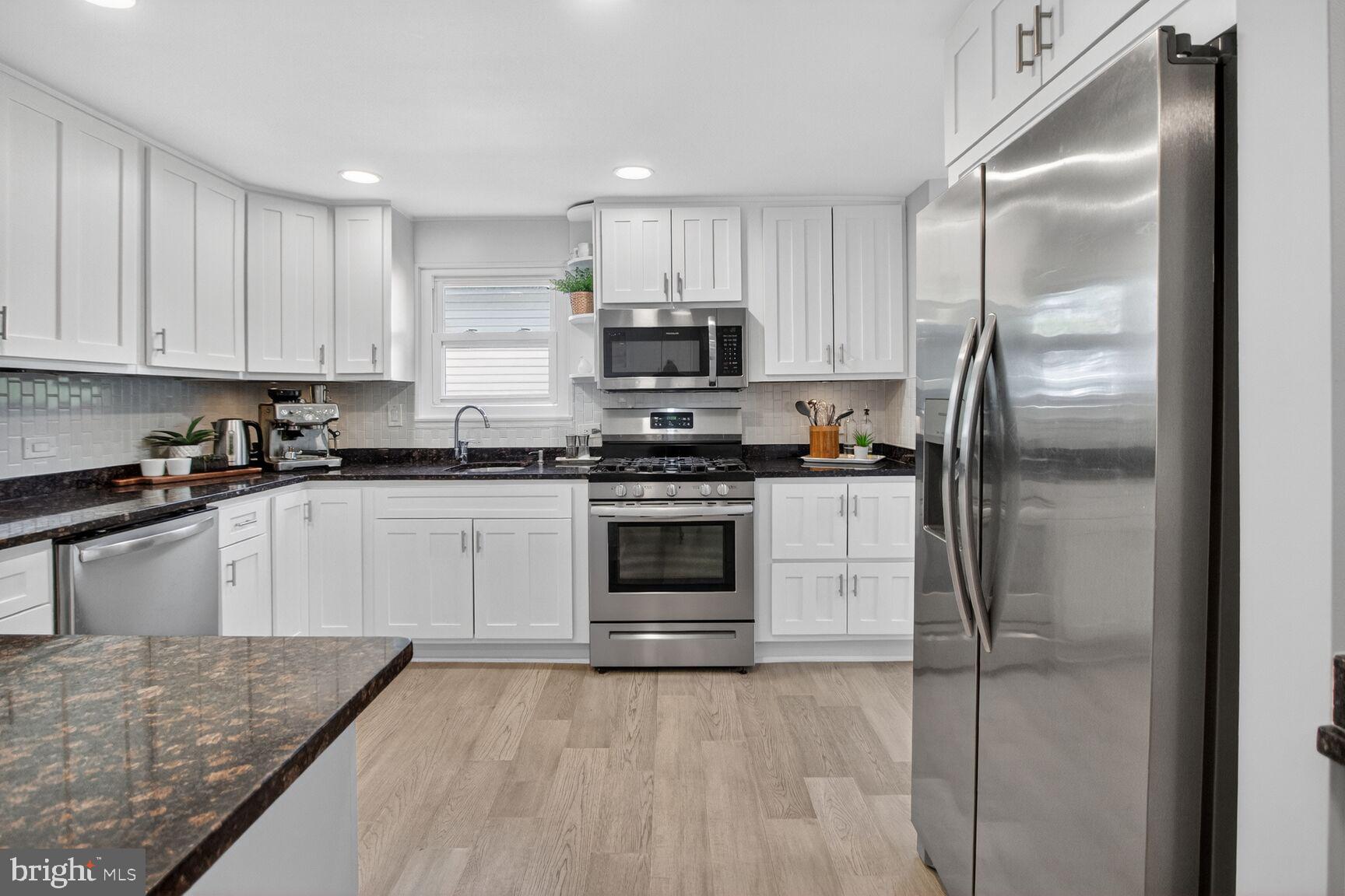 7007 Lemay Road Rockville, MD 20851 - Photo 7 of 37 a kitchen with a refrigerator stove and microwave