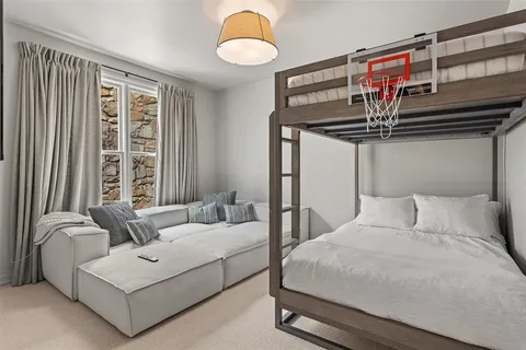 a bedroom with a bed couch and window