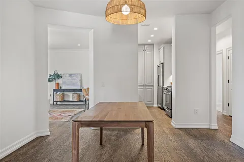 an entryway and a room with wooden floor