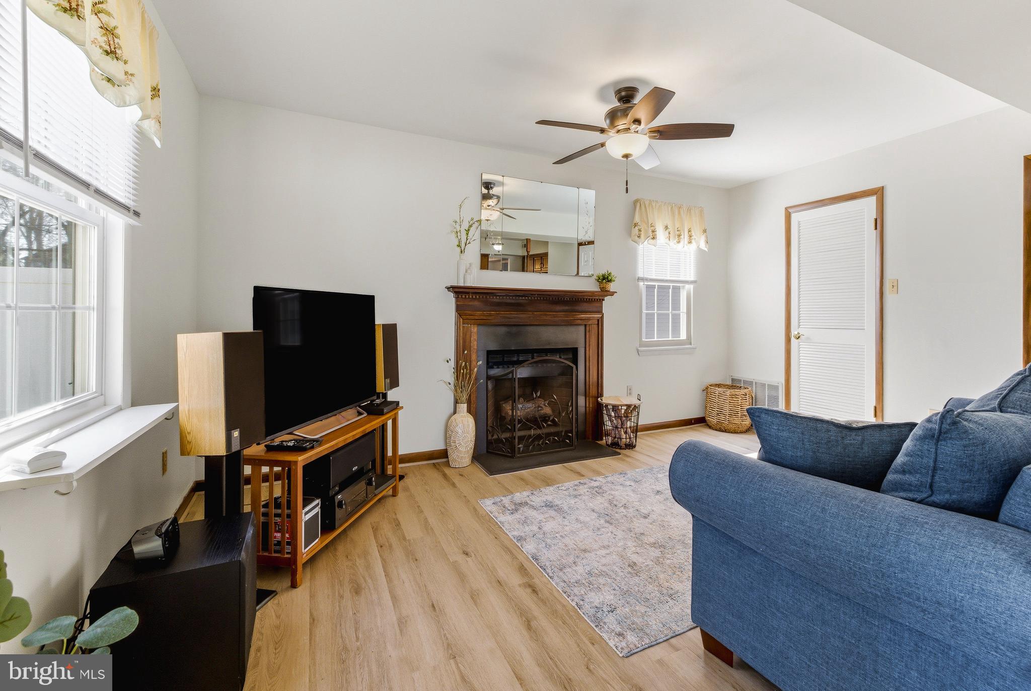 119 Robins Run West Swedesboro, NJ 08085 - Photo 12 of 20 a living room with furniture a fireplace and a flat screen tv