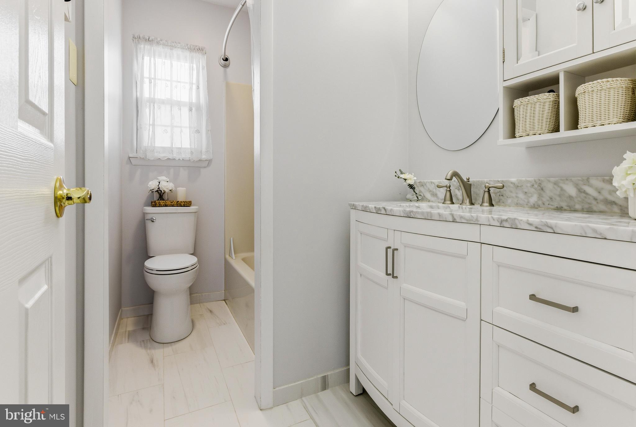 119 Robins Run West Swedesboro, NJ 08085 - Photo 16 of 20 a bathroom with a granite countertop toilet sink and mirror