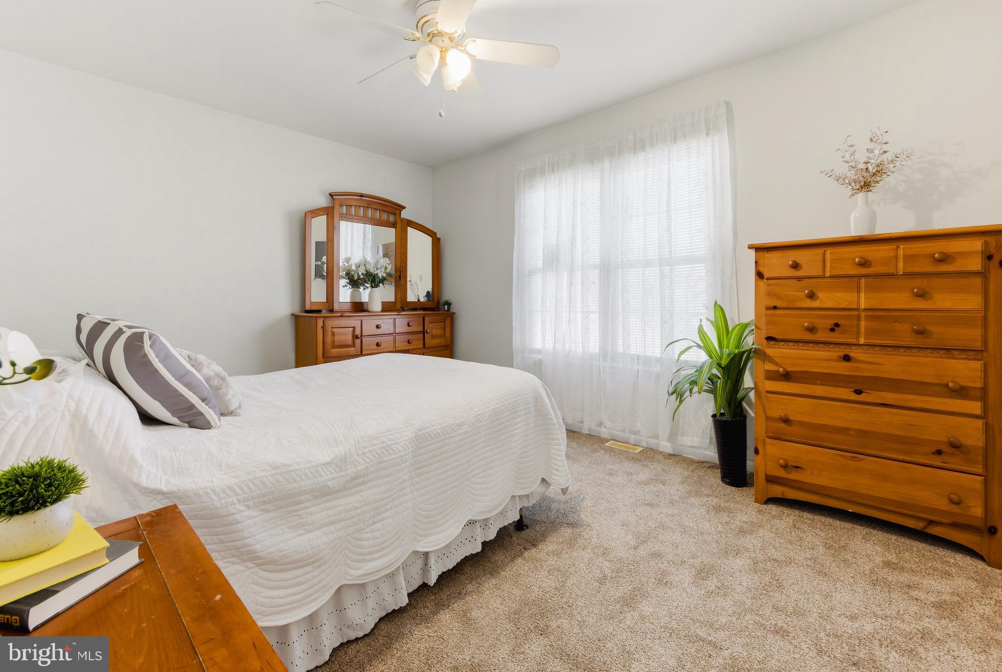119 Robins Run West Swedesboro, NJ 08085 - Photo 17 of 20 a bedroom with a bed and a chandelier
