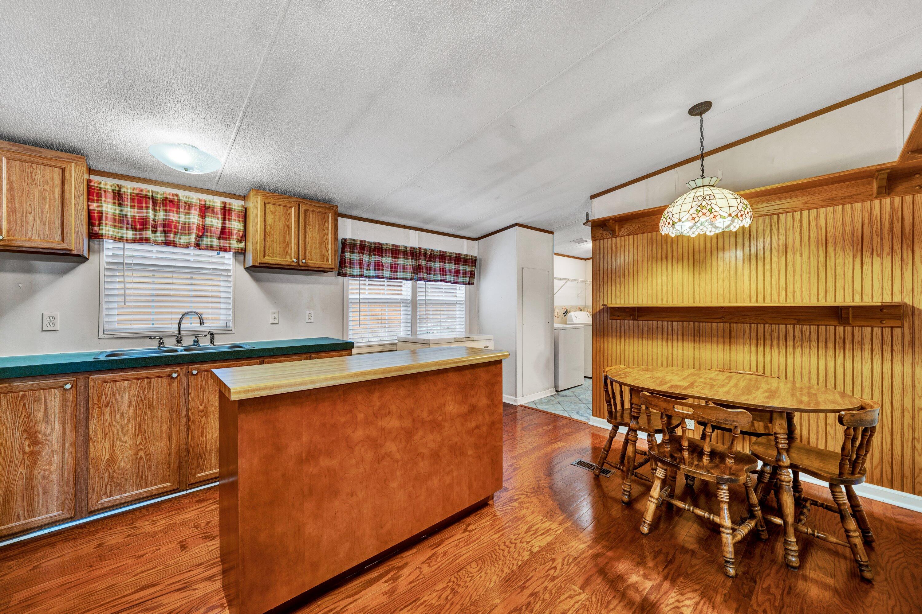 1150 Horseshoe Point Road Henry, VA 24102 - Photo 11 of 43 a kitchen with stainless steel appliances granite countertop a sink and a wooden floor