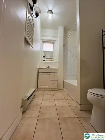 a bathroom with a sink a toilet and mirror