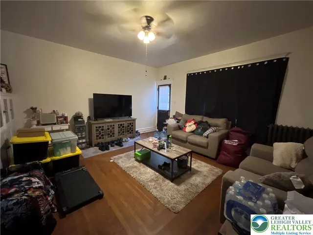 a living room with furniture and a flat screen tv
