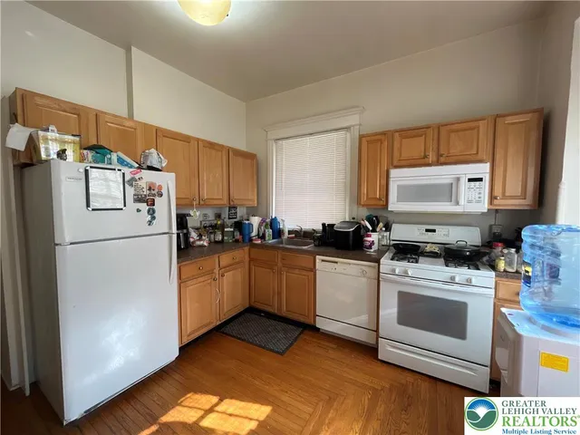 a kitchen with a stove top oven and refrigerator