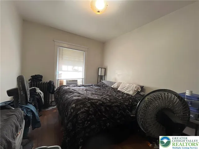 a bed sitting in a bedroom next to a window