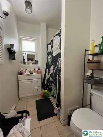 a room with a couch and a potted plant