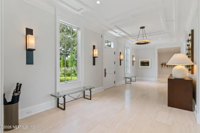 a living room with furniture and a large window with garden view