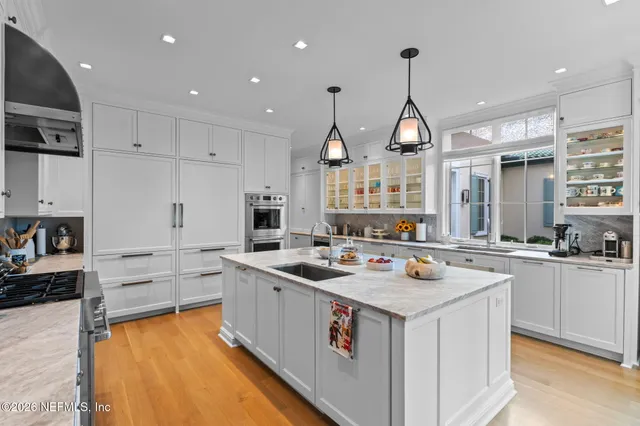 a bedroom with a bed furniture and a large window