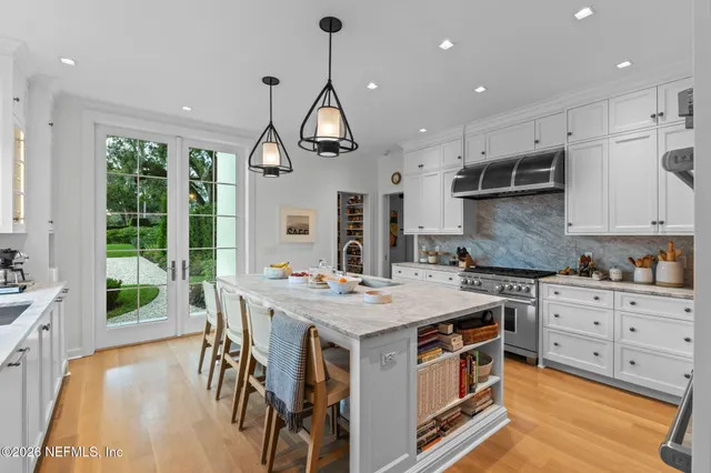 a view of a dining room with furniture wooden floor and chandelier
