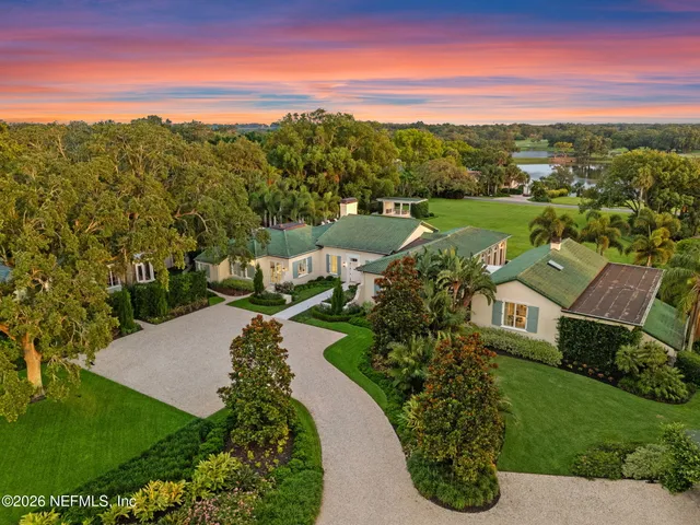 a view of a patio with chairs and table under an umbrella