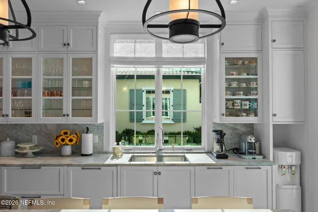 a living room with furniture a flat screen tv and a large window