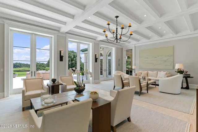 a living room with furniture a fireplace and a large window