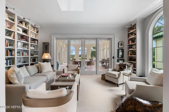 a view of a chair and table in front of a house with a yard