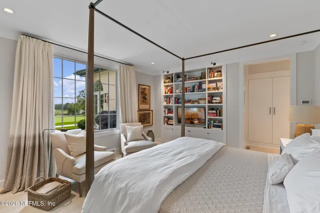 an aerial view of a houses with a yard and lake view