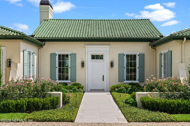 a living room with furniture and floor to ceiling windows