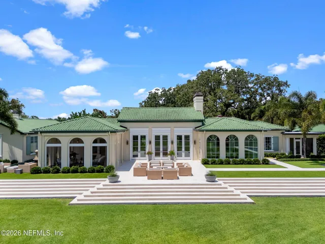 a living room with furniture a fireplace and a potted plant
