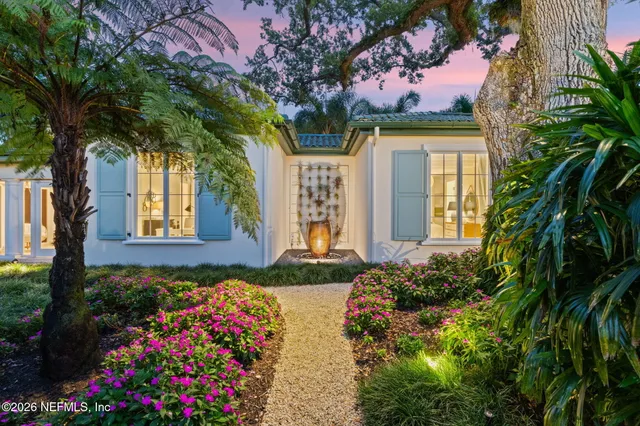 a living room with furniture and large windows