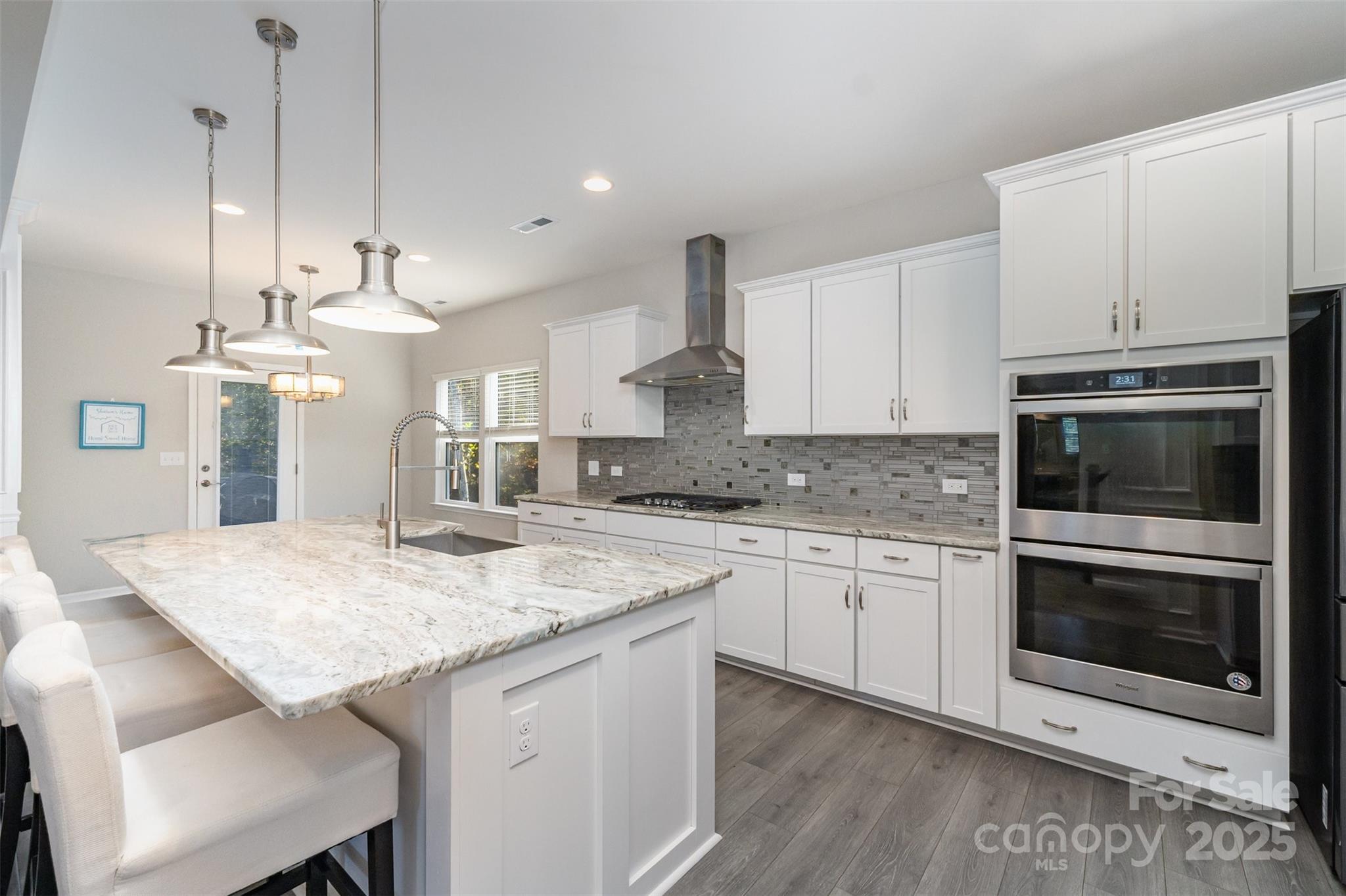 423 Crisfield Court York, SC 29745 - Photo 15 of 45 a kitchen with stainless steel appliances granite countertop a kitchen island hardwood floor sink and stove