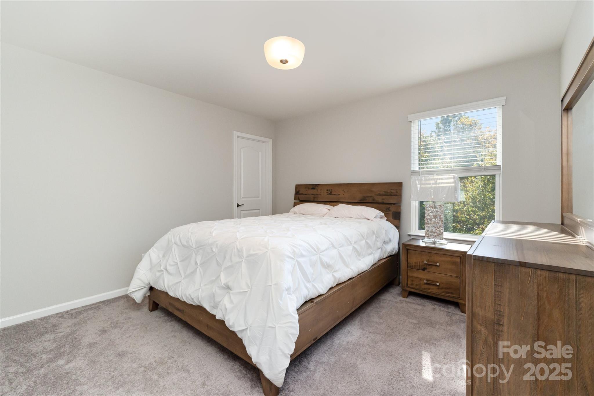 423 Crisfield Court York, SC 29745 - Photo 28 of 45 a bed sitting in a bedroom next to a window