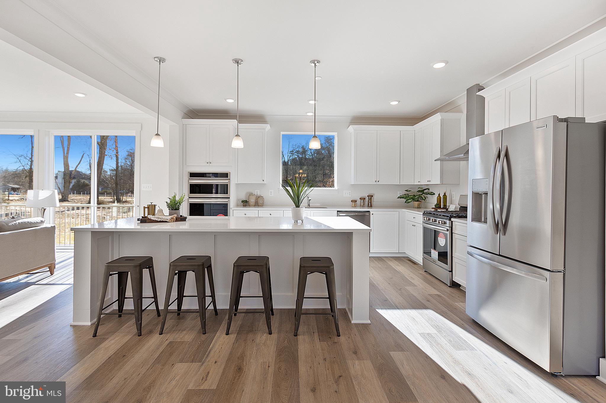 1333 German Driveway Hanover, MD 21076 - Photo 11 of 56 a kitchen with white cabinets stainless steel appliances and kitchen island