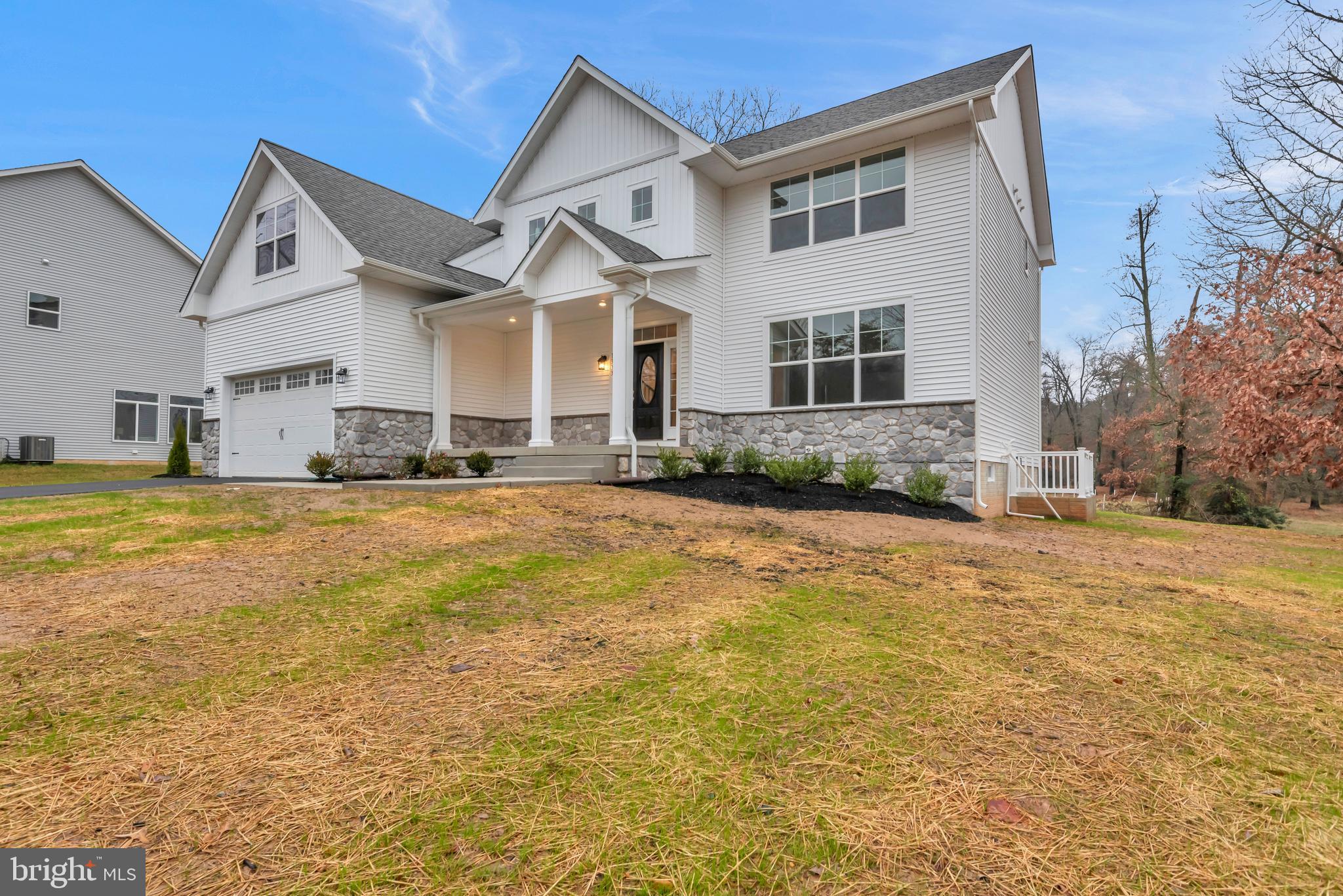 1333 German Driveway Hanover, MD 21076 - Photo 3 of 56 a view of a white house with a big yard and large trees