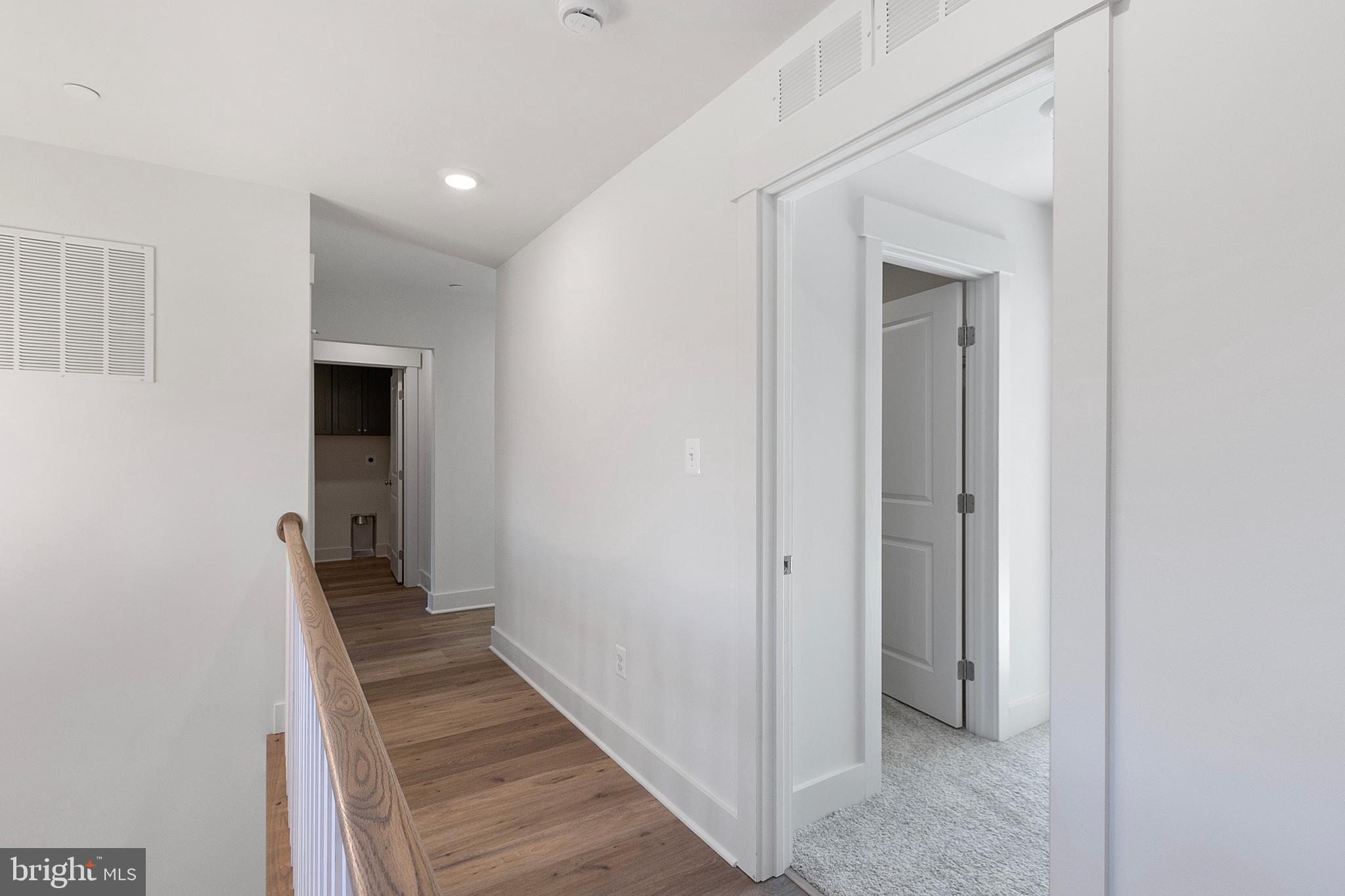 1333 German Driveway Hanover, MD 21076 - Photo 33 of 56 a view of a hallway with wooden floor and staircase