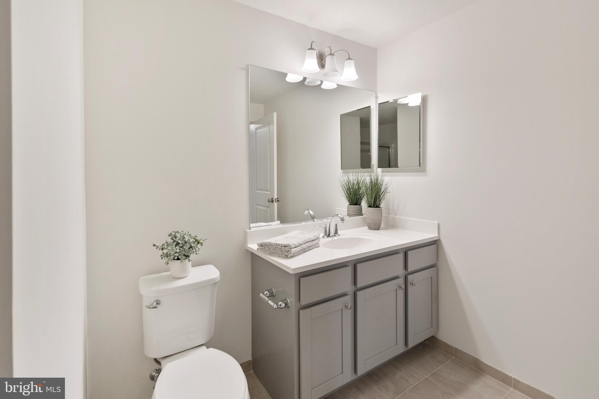 1333 German Driveway Hanover, MD 21076 - Photo 43 of 56 a bathroom with a toilet sink and mirror