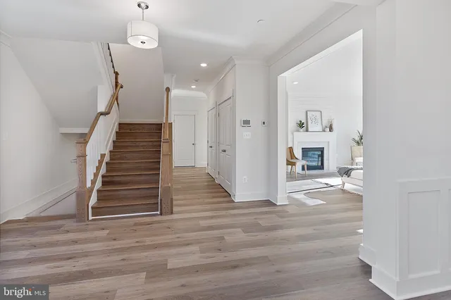 a view of a livingroom with wooden floor and stairs