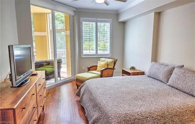 a bedroom with two beds and a flat screen tv